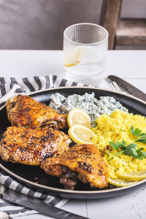 Baked chicken thighs with cauliflower rice and spinach dip