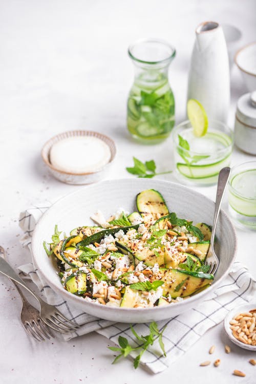 Grilled zucchini salad with goat cheese, pine nuts, and mint