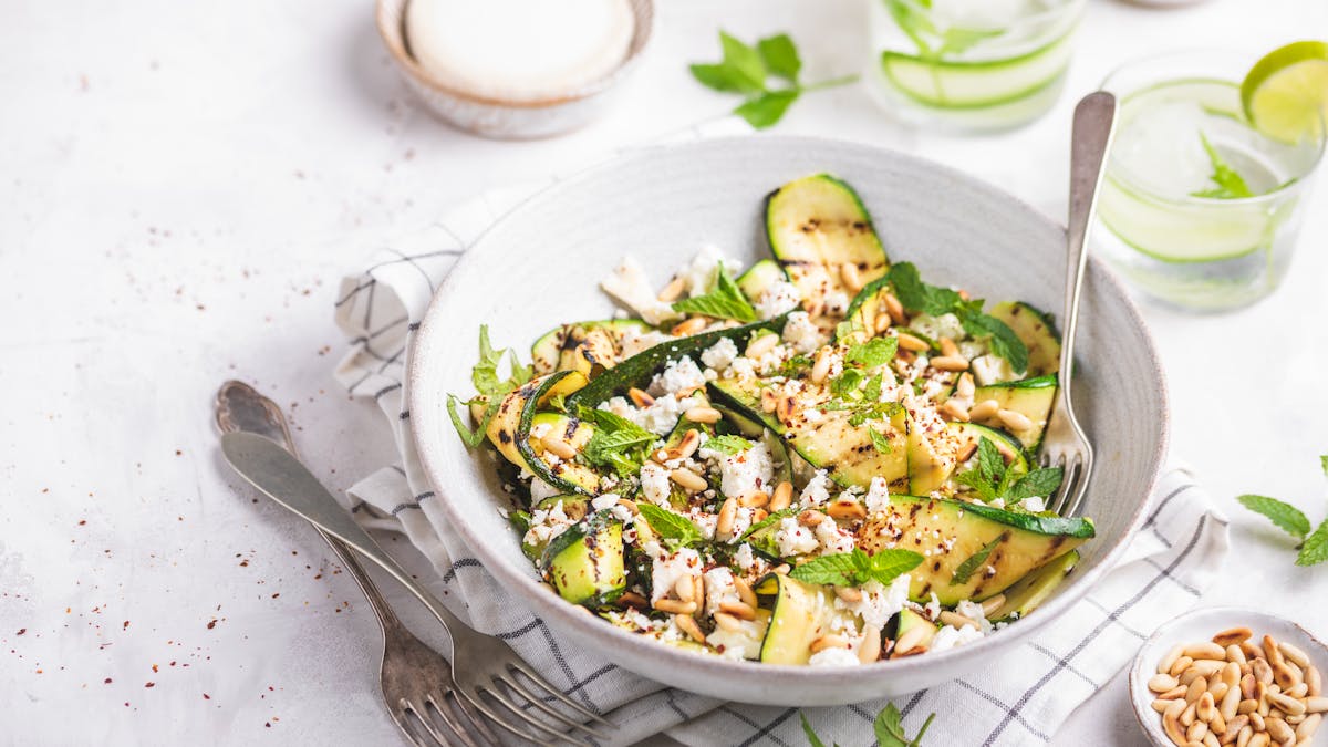 Grilled zucchini salad with goat cheese, pine nuts, and mint