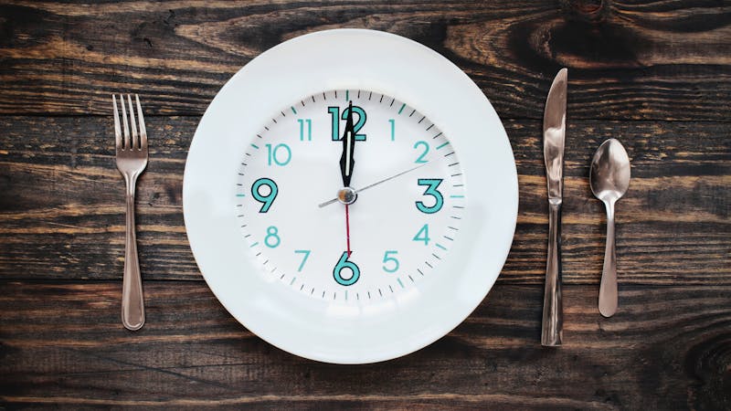 Twelve hour intermittent fasting time concept with clock on plate