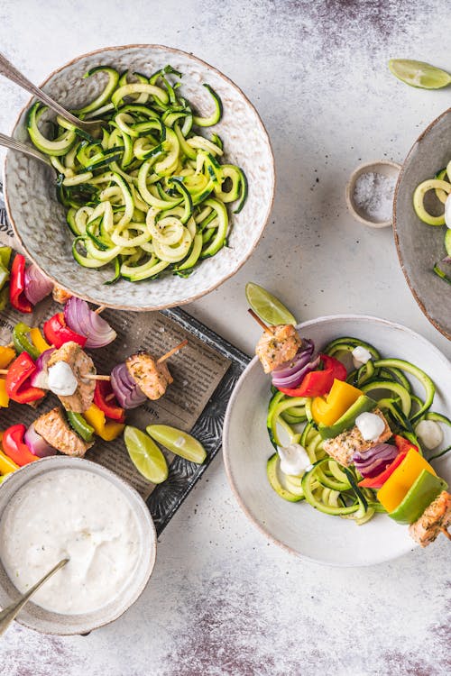 Rainbow cajun salmon skewers with zoodles & garlic lime sauce
