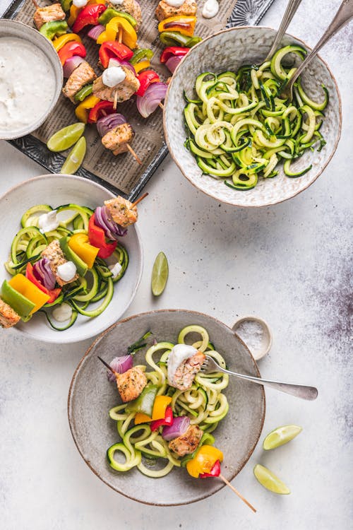 Rainbow cajun salmon skewers with zoodles & garlic lime sauce